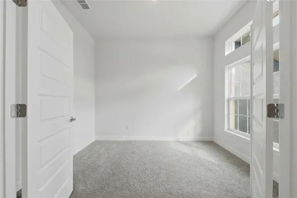 a bathroom with a granite countertop double vanity sink a mirror and a shower