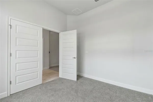 a kitchen with a stove and a wooden floor