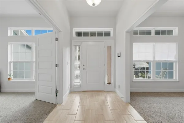 a kitchen with stainless steel appliances granite countertop a stove a sink and a white cabinets