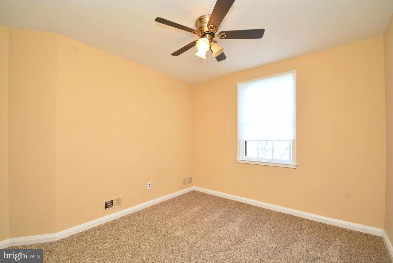 19 Cardinal Road Essex, MD 21221 - Photo 13 of 23 an empty room with a window and a fan
