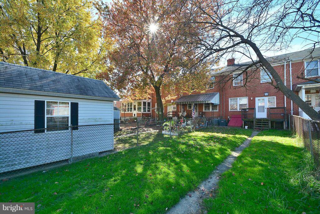 19 Cardinal Road Essex, MD 21221 - Photo 21 of 23 a view of a yard in front of a house with plants and large tree
