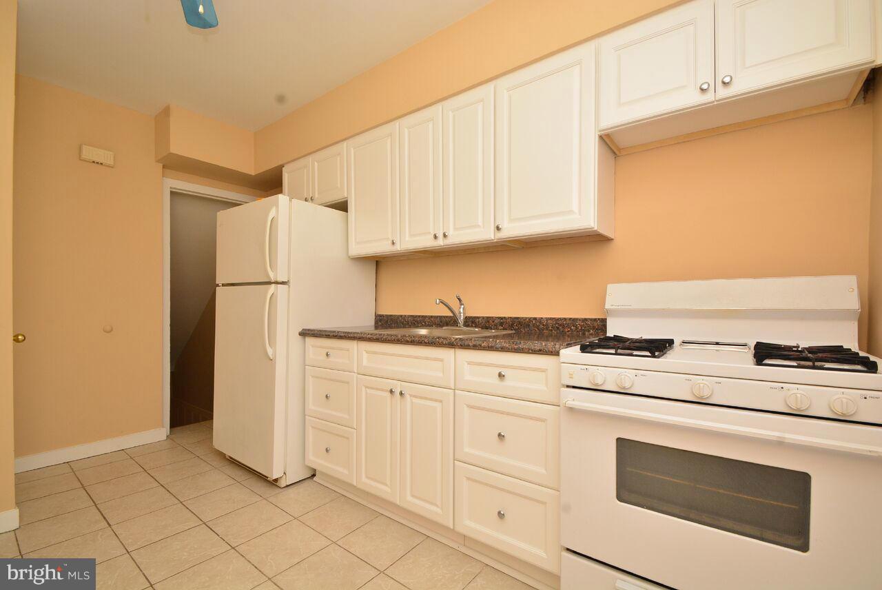 19 Cardinal Road Essex, MD 21221 - Photo 6 of 23 a kitchen with white cabinets and white appliances