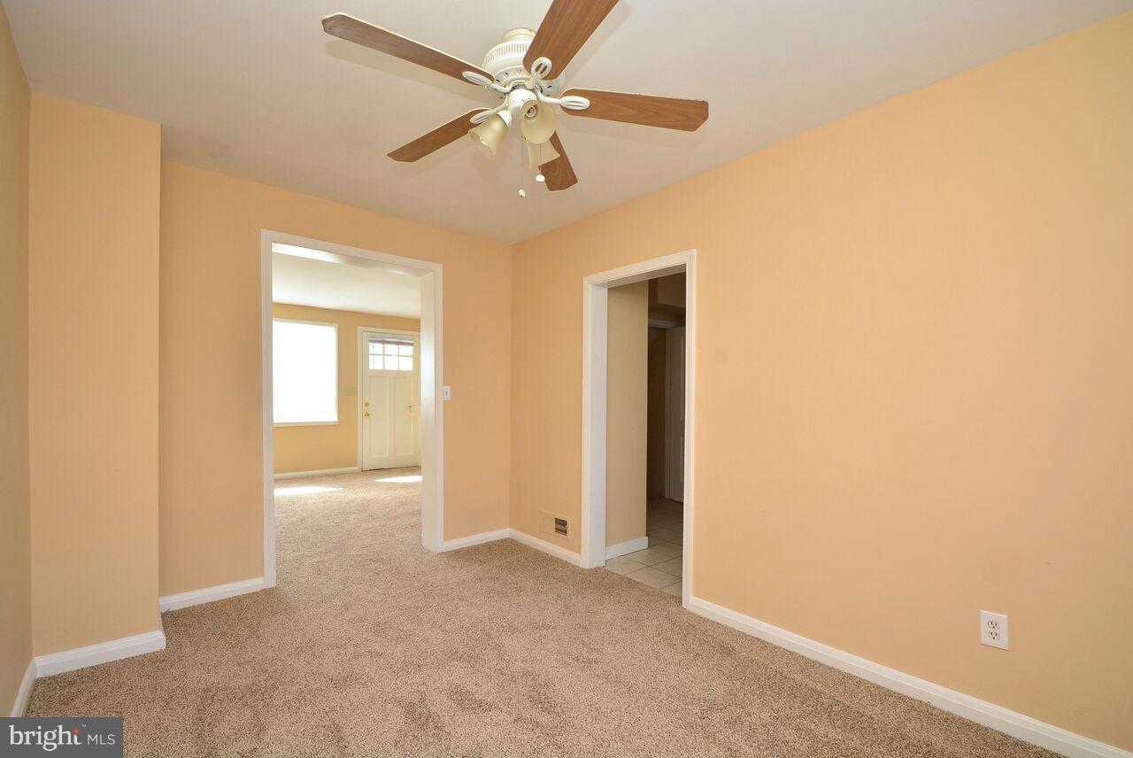 19 Cardinal Road Essex, MD 21221 - Photo 10 of 23 a view of a livingroom with a ceiling fan and window
