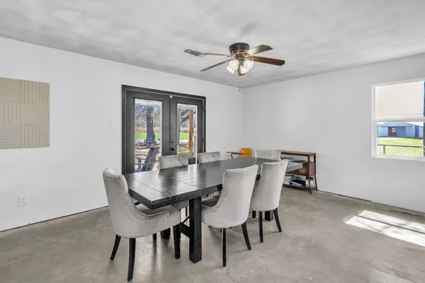 a view of a dining room with furniture and window