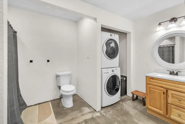 a bathroom with a washing machine and a washer dryer