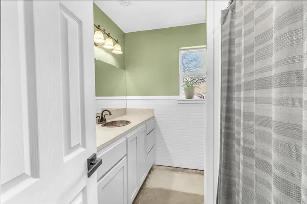 a bathroom with a sink a mirror and a shower