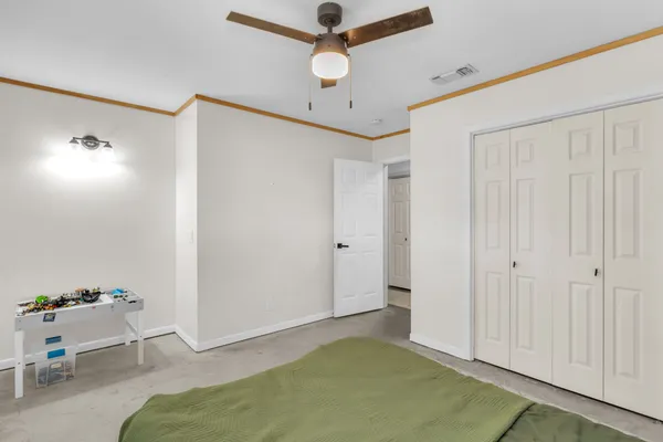 a living room with furniture and a ceiling fan