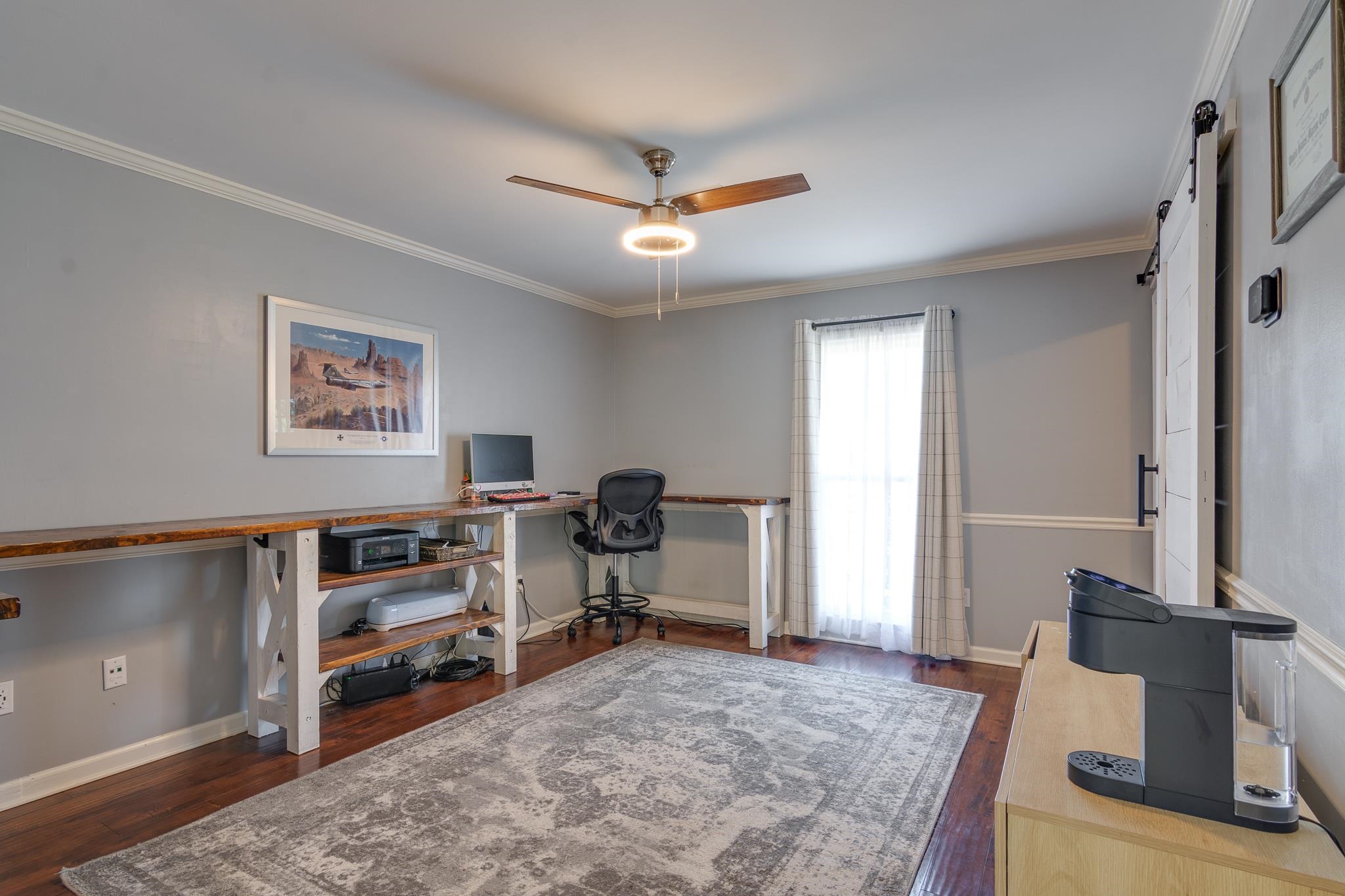 608 King Ridge Cove Collierville, TN 38017 - Photo 14 of 29 Wood-finish flooring, ceiling fan with integrated lighting, built-in shelving, crown molding, and a sliding barn door