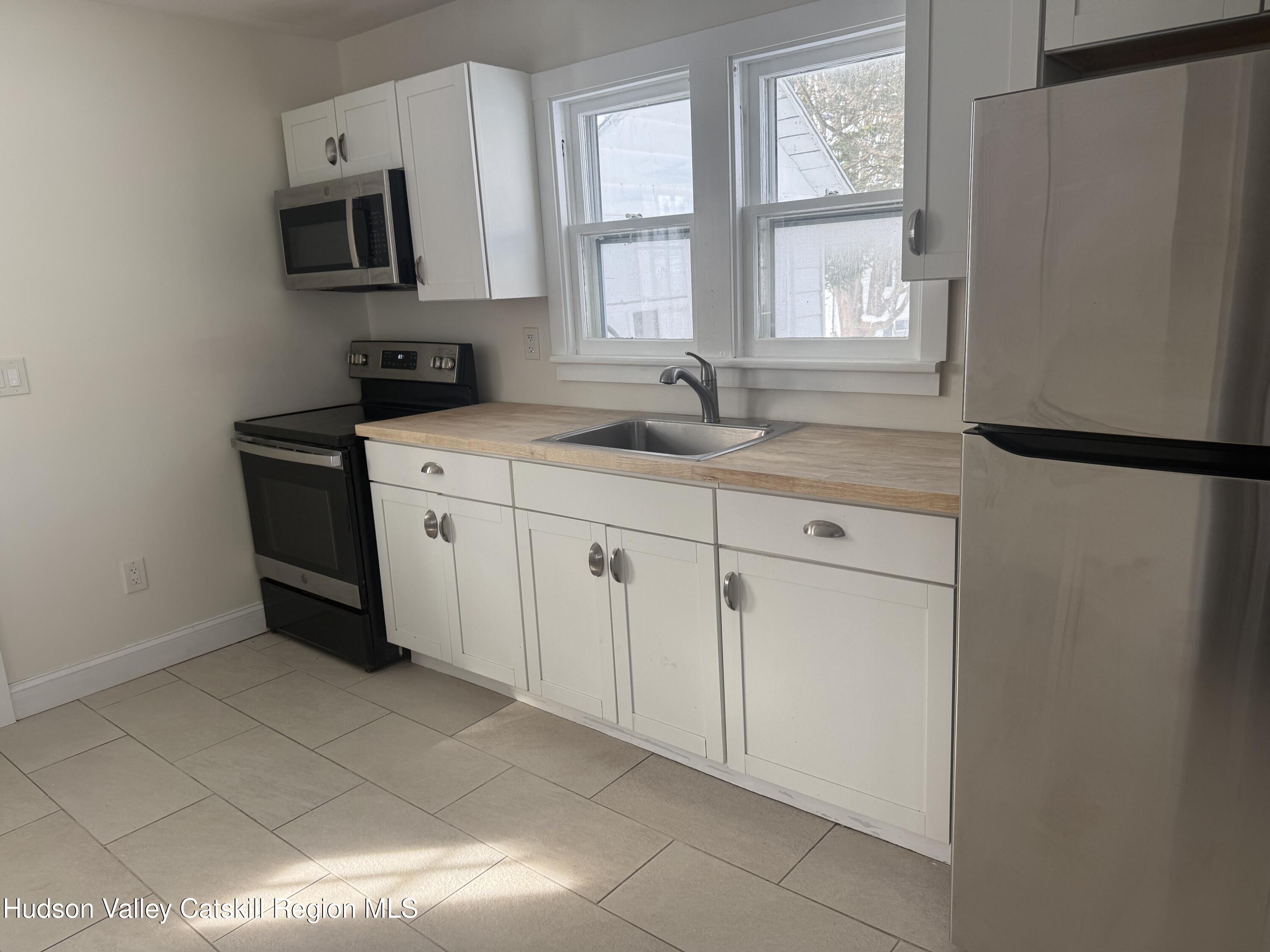 222 Zandhoek Road Hurley, NY 12443 - Photo 8 of 23 a kitchen with stainless steel appliances a refrigerator sink and microwave