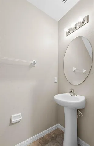 a bathroom with a sink a mirror and vanity