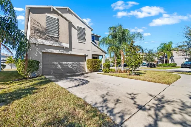 a front view of a house with a yard and garage