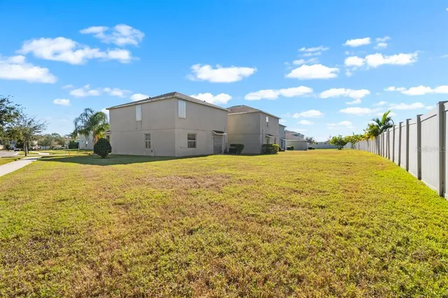 a view of a big yard with table and chair