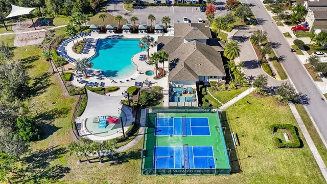 an aerial view of a house with swimming pool and outdoor seating