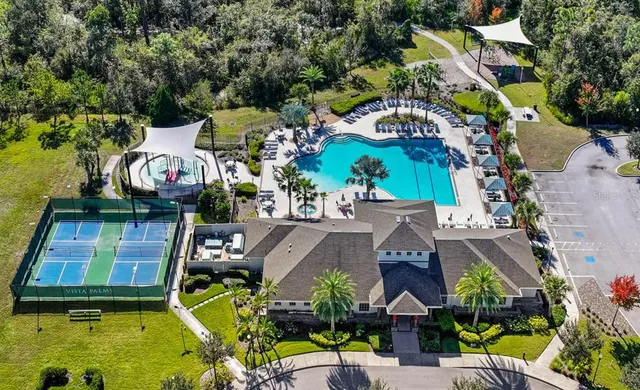 an aerial view of a house with swimming pool and outdoor seating