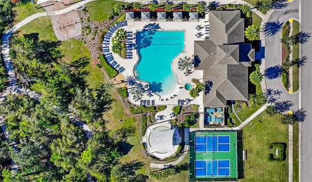 an aerial view of residential house with outdoor space and swimming pool