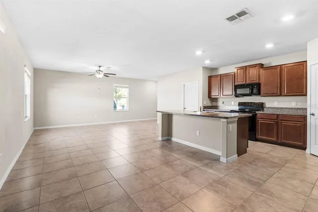 a view of kitchen with microwave and cabinets