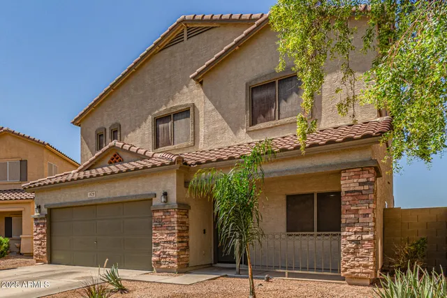 a front view of a house with garage