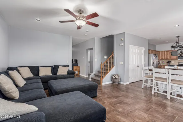 a view of a dining room and kitchen with stainless steel appliances