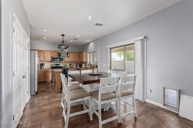 a kitchen that has a lot of cabinets a sink and appliances