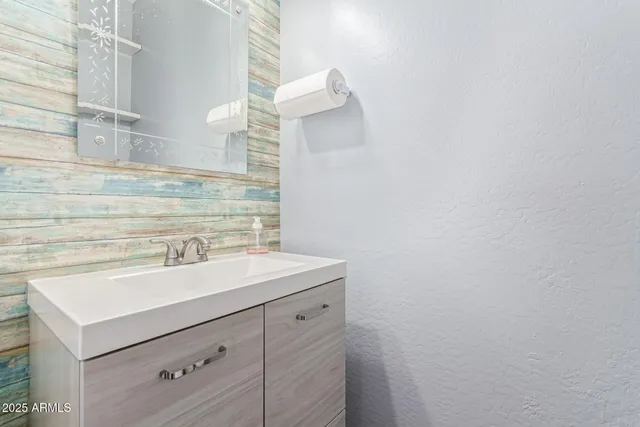 a spacious bedroom with a bed and a chandelier