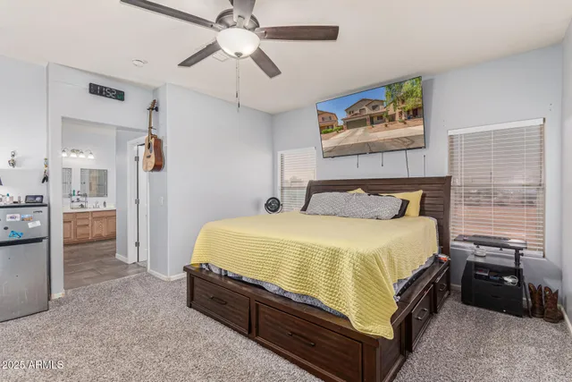 a bedroom with a bed furniture and a ceiling fan