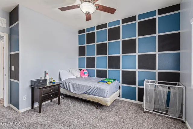 a bedroom with a bed and a tv