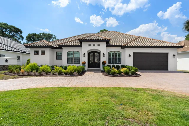 a front view of a house with a garden