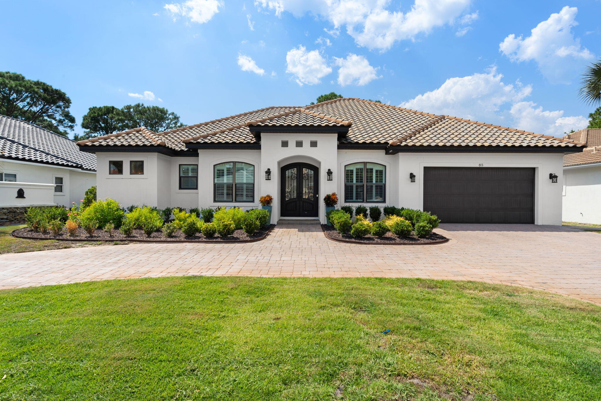 85 Garnet Place Destin, FL 32541 - Photo 1 of 50 a front view of a house with a garden