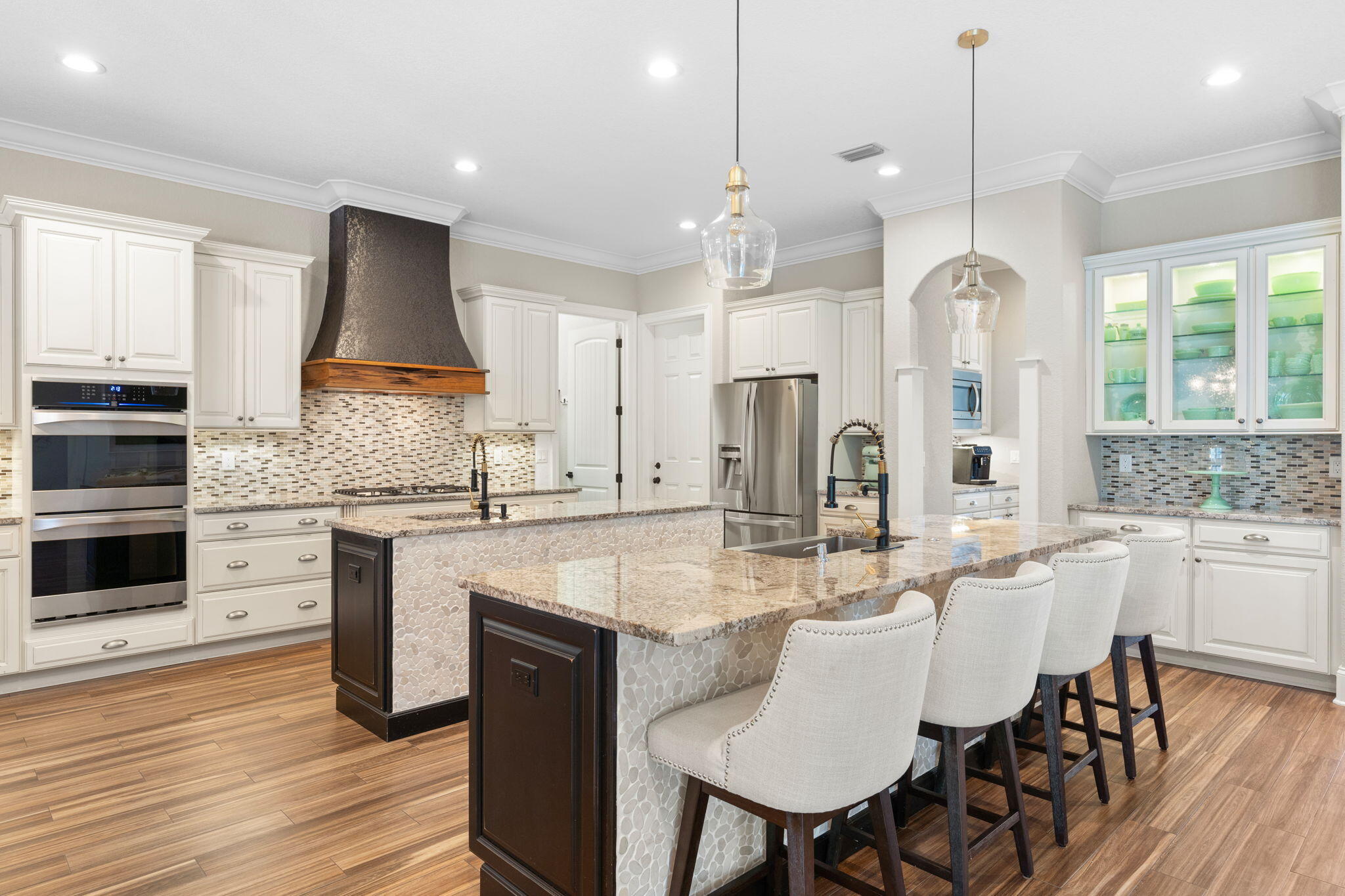 85 Garnet Place Destin, FL 32541 - Photo 13 of 50 a kitchen with stainless steel appliances kitchen island granite countertop a kitchen island hardwood floor sink and stove