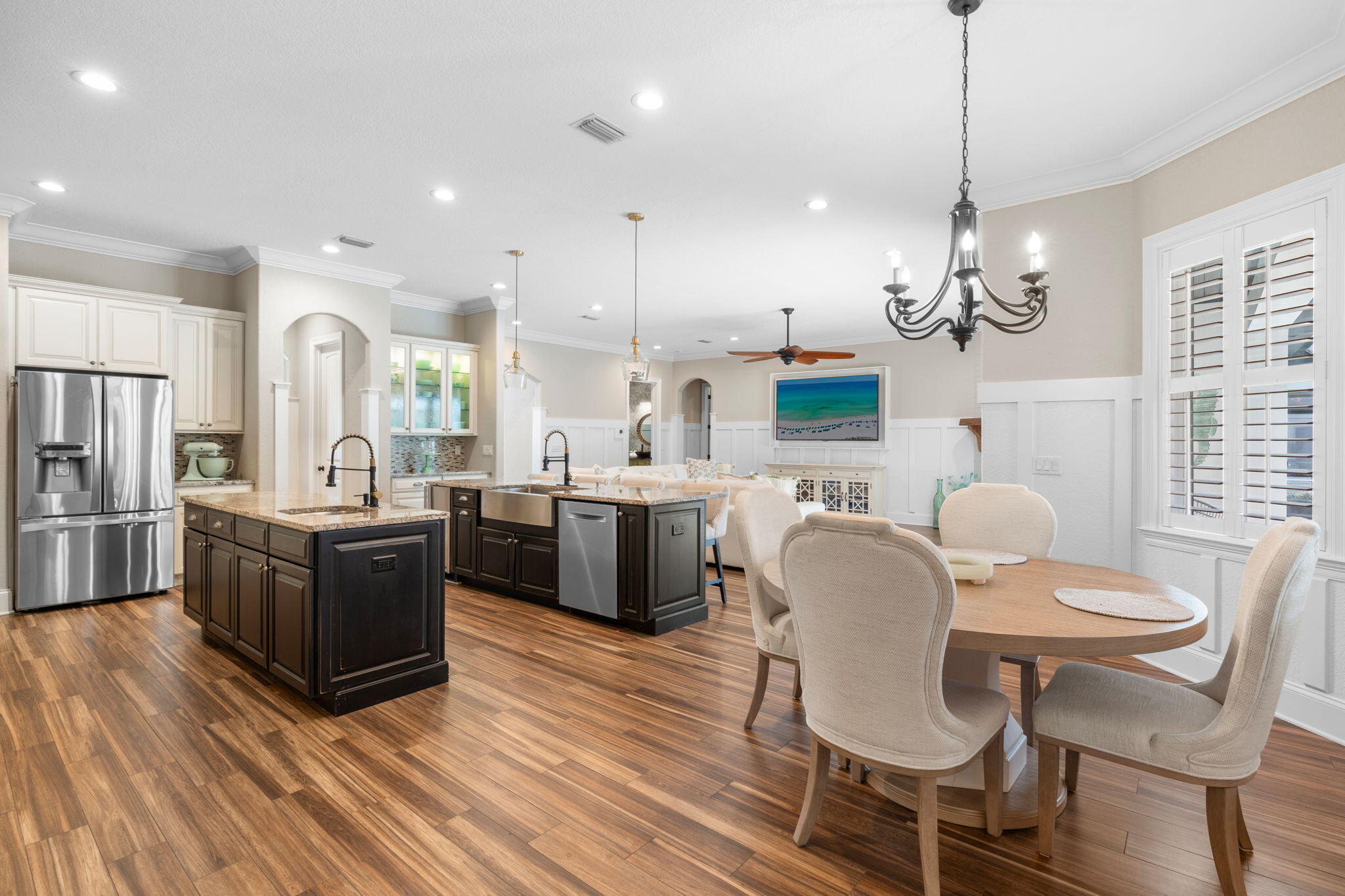 85 Garnet Place Destin, FL 32541 - Photo 17 of 50 a kitchen with stainless steel appliances kitchen island granite countertop a table chairs and a refrigerator