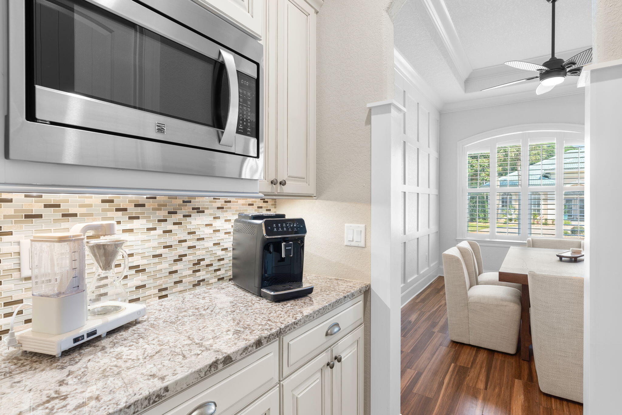 85 Garnet Place Destin, FL 32541 - Photo 18 of 50 a kitchen with granite countertop white cabinets and black stainless steel appliances