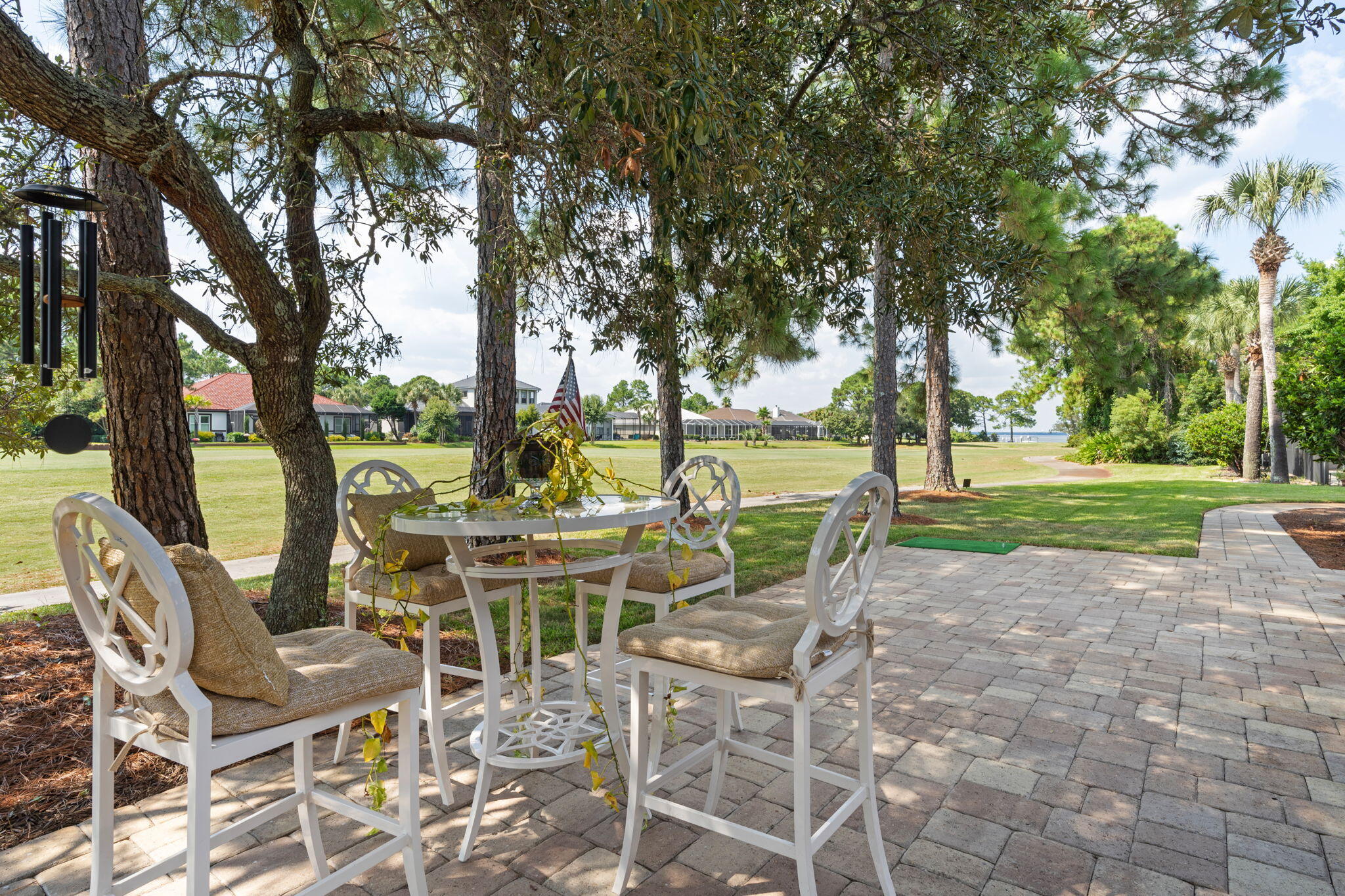 85 Garnet Place Destin, FL 32541 - Photo 39 of 50 a view of a patio with table and chairs and couches with large trees