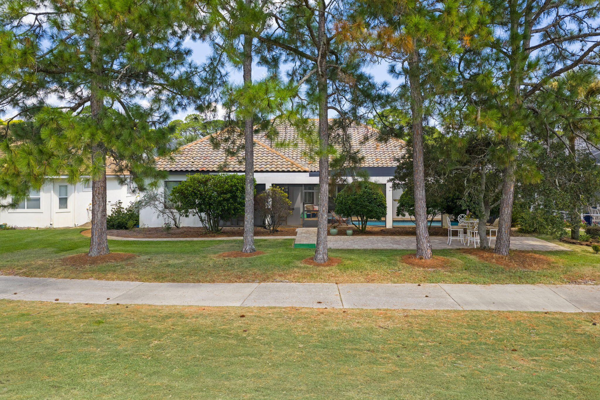 85 Garnet Place Destin, FL 32541 - Photo 41 of 50 a view of swimming pool with lawn chairs and large trees