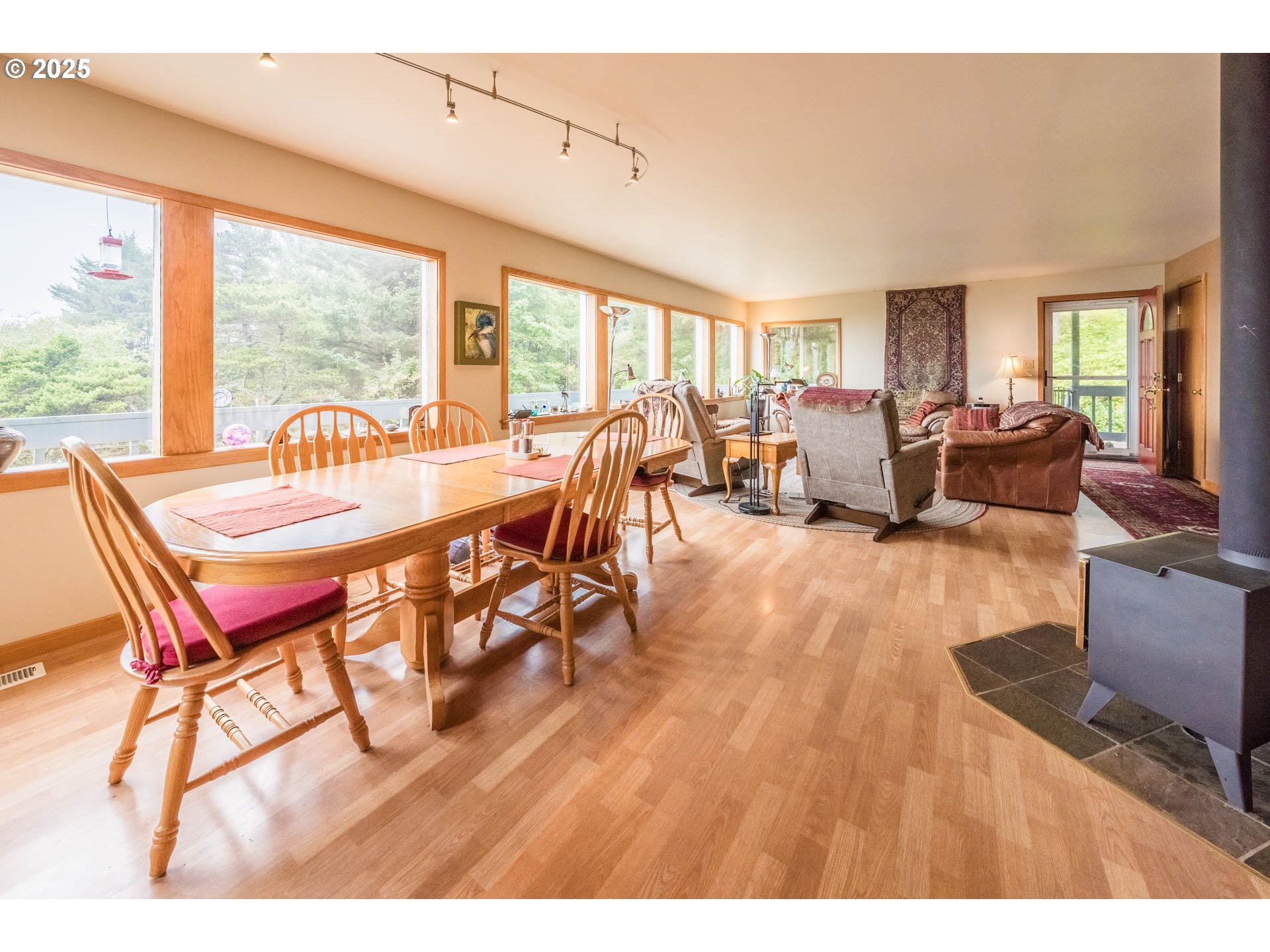 117 Southwest 66th South Beach, OR 97366 - Photo 11 of 40 a dining room with furniture a chandelier and wooden floor