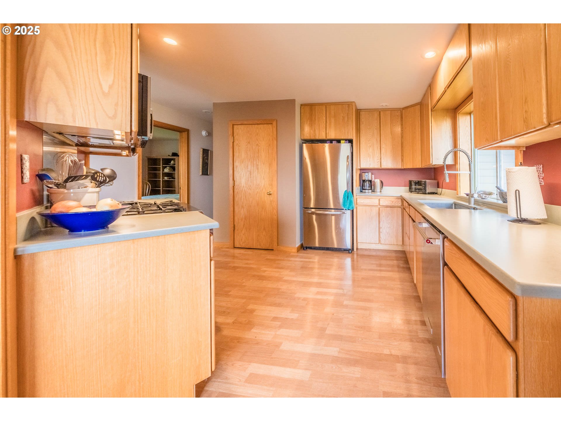 117 Southwest 66th South Beach, OR 97366 - Photo 14 of 40 a kitchen with stainless steel appliances granite countertop a sink a stove and a refrigerator