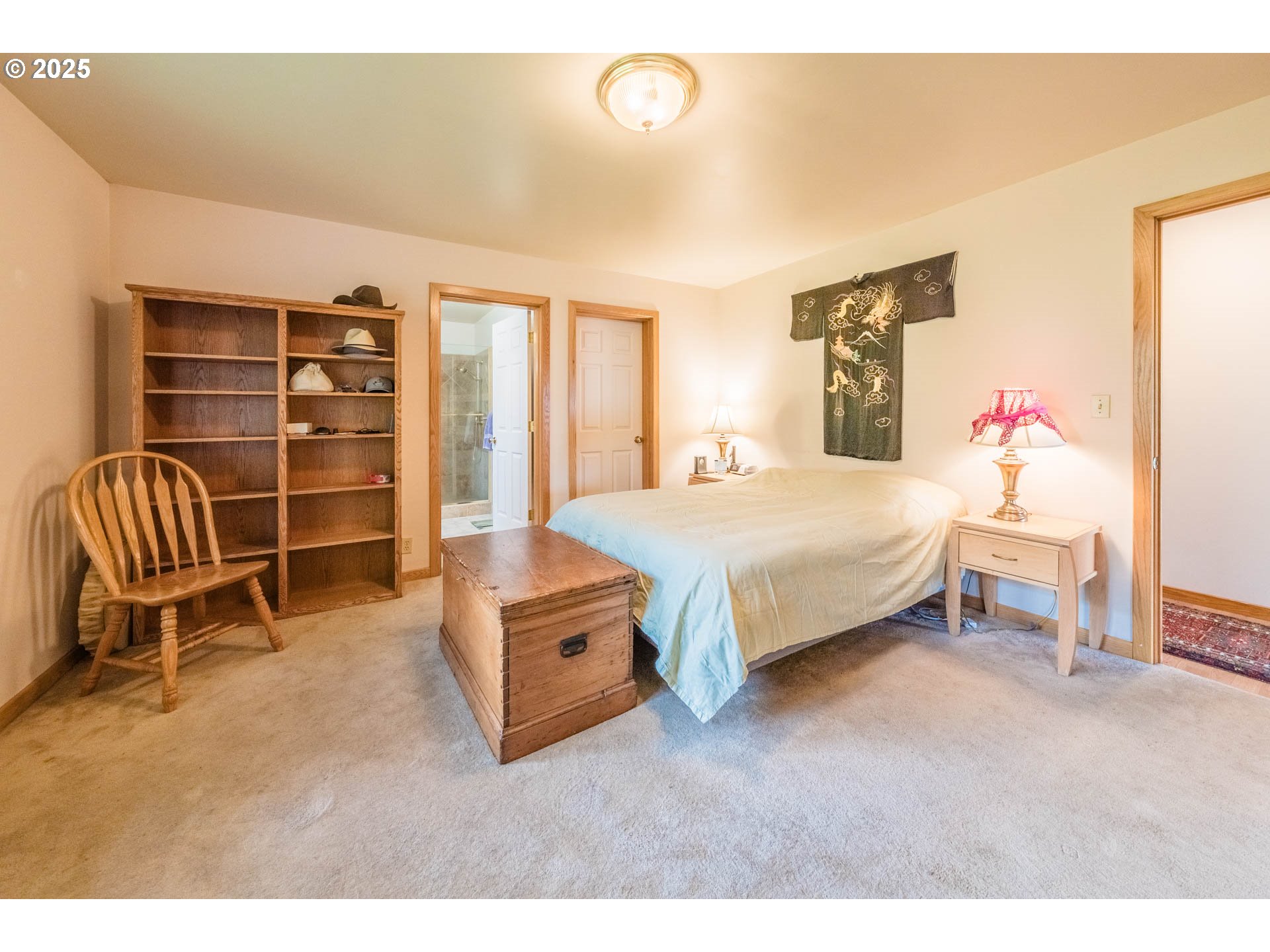 117 Southwest 66th South Beach, OR 97366 - Photo 16 of 40 a bedroom with a bed and a chair