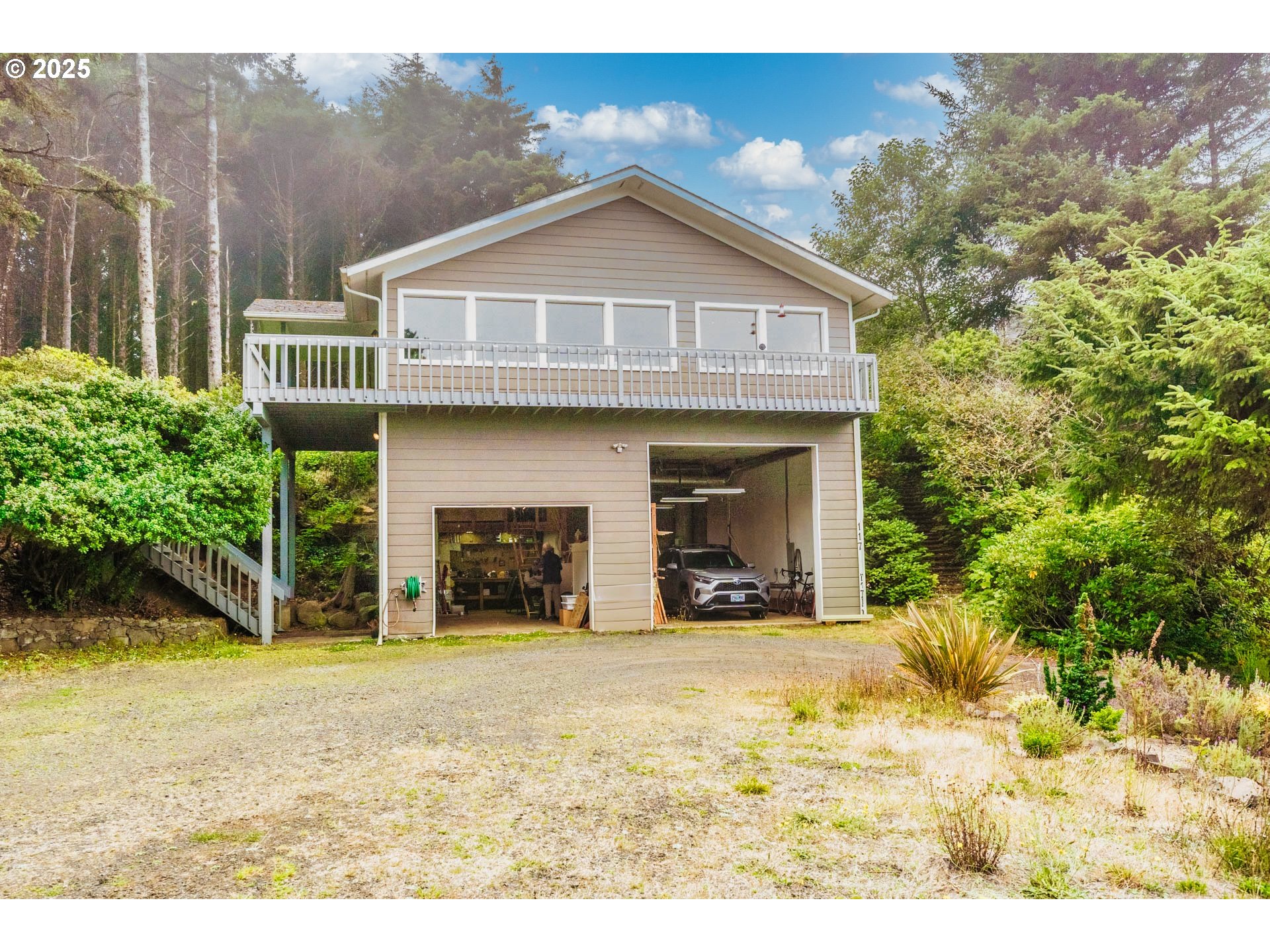 117 Southwest 66th South Beach, OR 97366 - Photo 28 of 40 a view of a house with large windows and a yard with plants