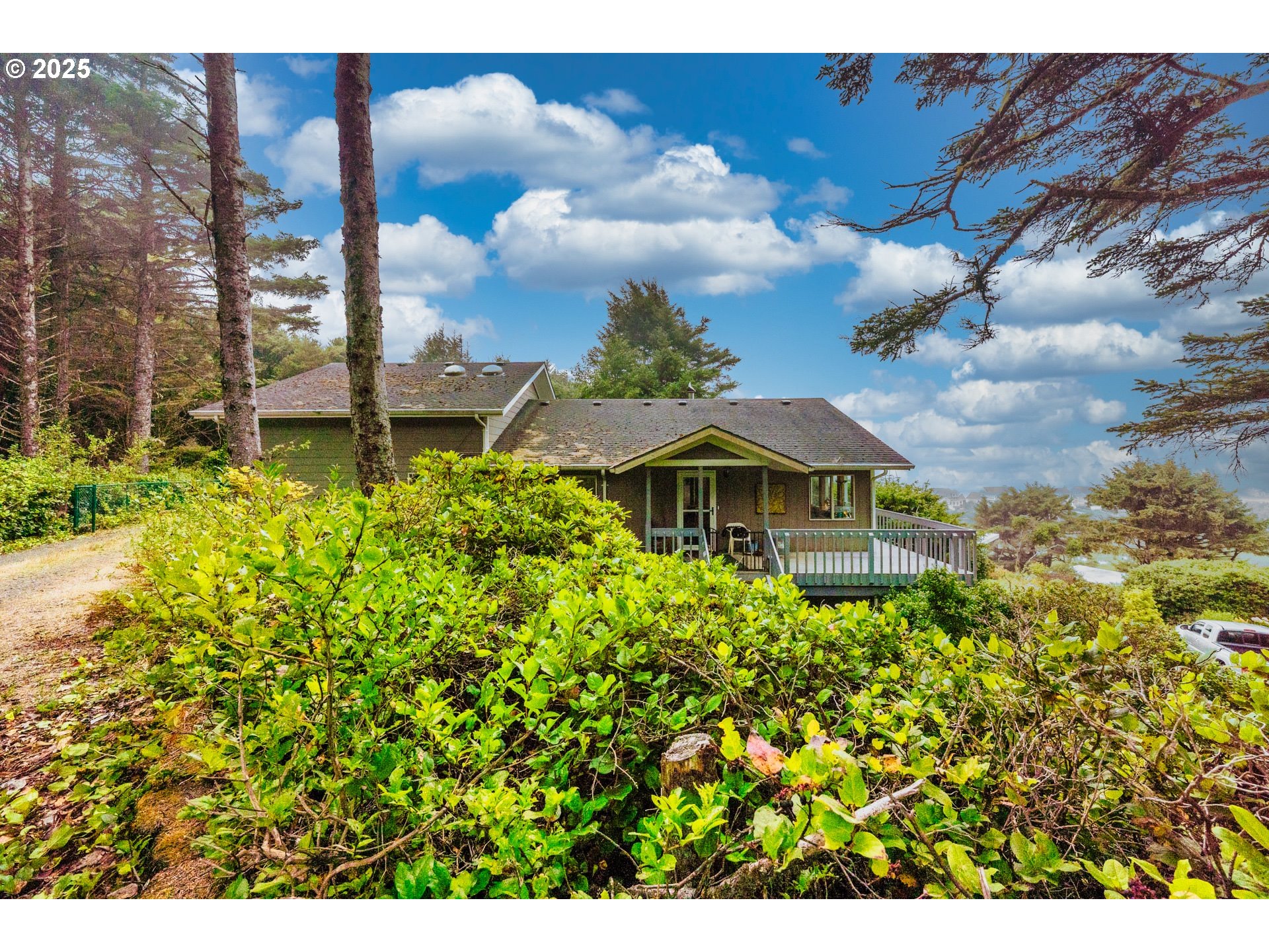 117 Southwest 66th South Beach, OR 97366 - Photo 33 of 40 a view of a garden with a bench under an umbrella