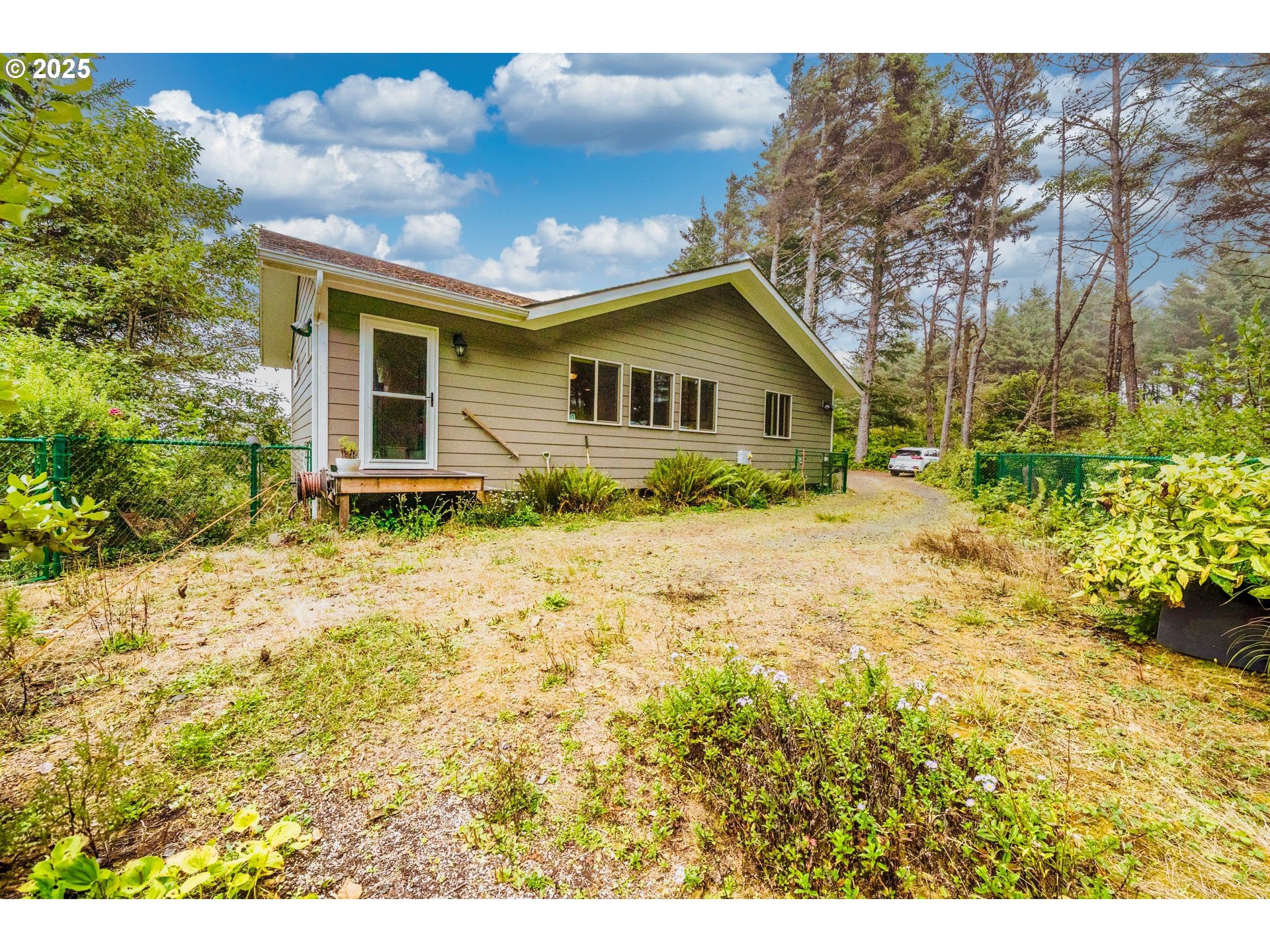 117 Southwest 66th South Beach, OR 97366 - Photo 35 of 40 a front view of house with yard and trees around