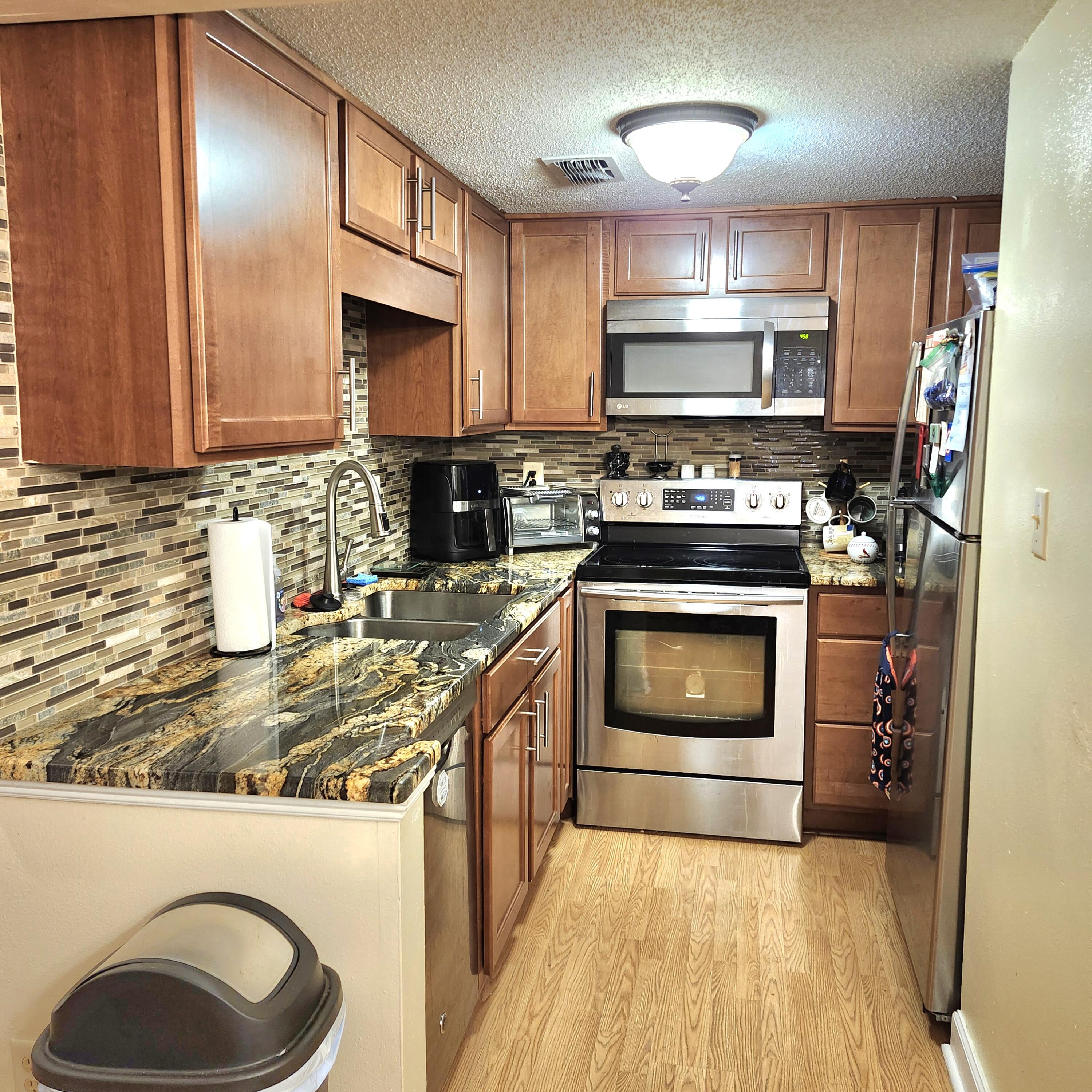 101 Old Ferry Road, Unit 8D Shalimar, FL 32579 - Photo 2 of 21 a kitchen with a stove and a sink
