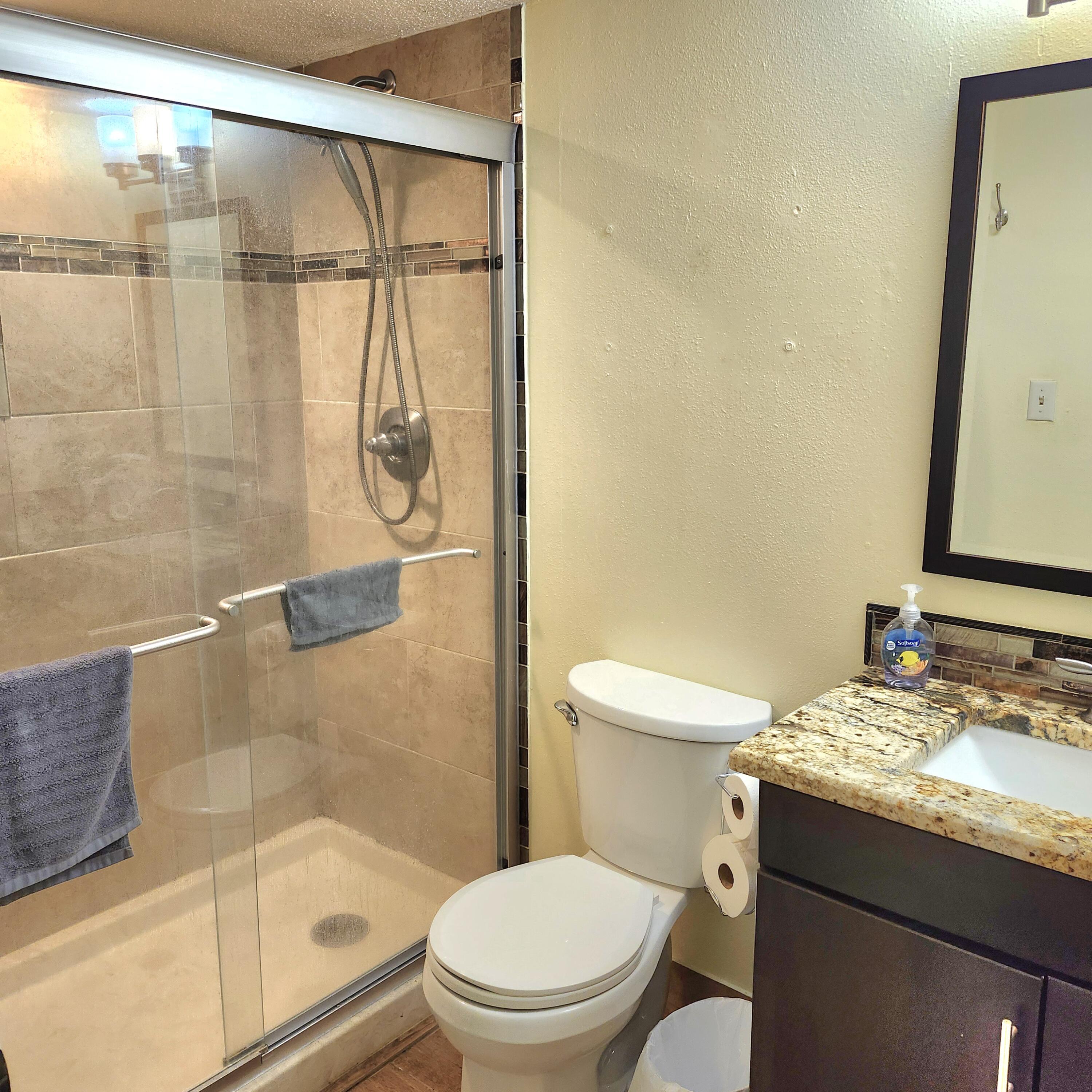 101 Old Ferry Road, Unit 8D Shalimar, FL 32579 - Photo 4 of 21 a bathroom with a granite countertop sink toilet and shower