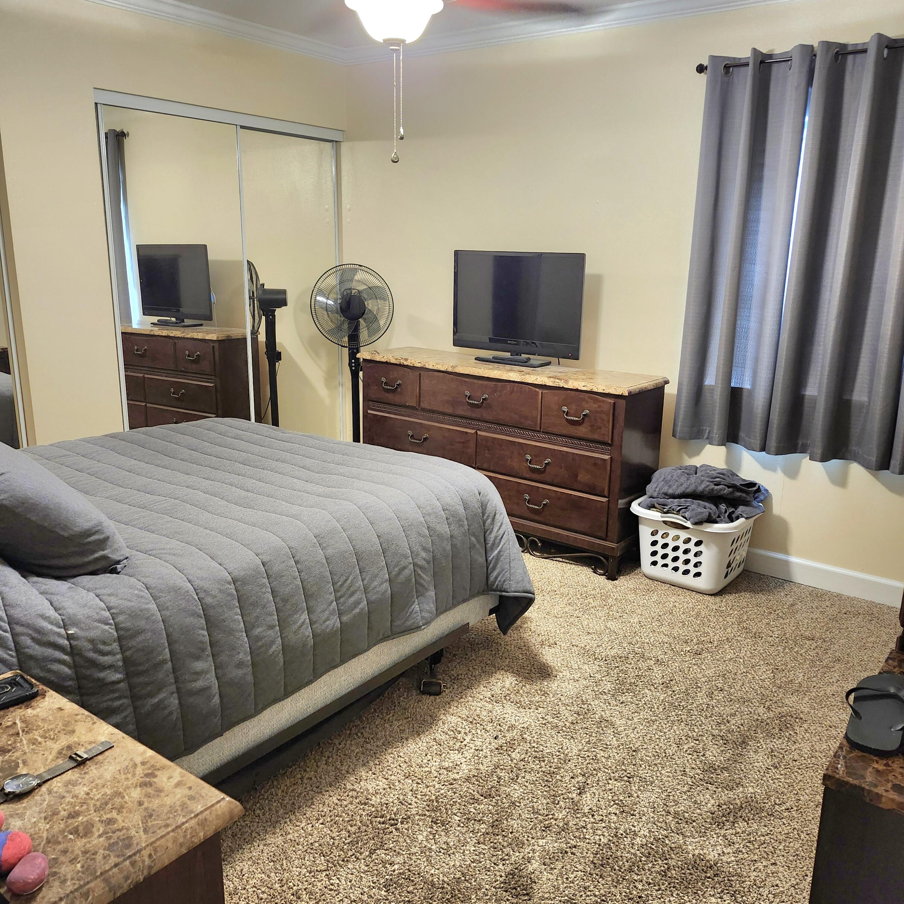 101 Old Ferry Road, Unit 8D Shalimar, FL 32579 - Photo 5 of 21 a bedroom with a bed and a television