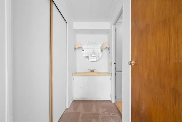 a white toilet sitting next to a bathroom sink