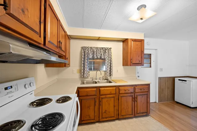 a bathroom with a sink a bed and a mirror
