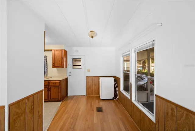 a view of kitchen with sink and refrigerator