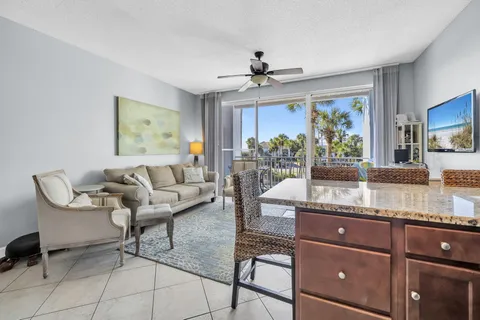 a living room with stainless steel appliances granite countertop furniture and a window