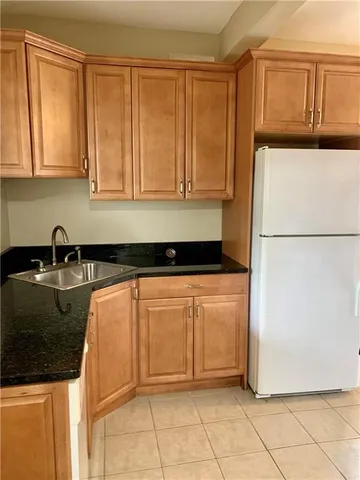 a kitchen with a refrigerator and a sink