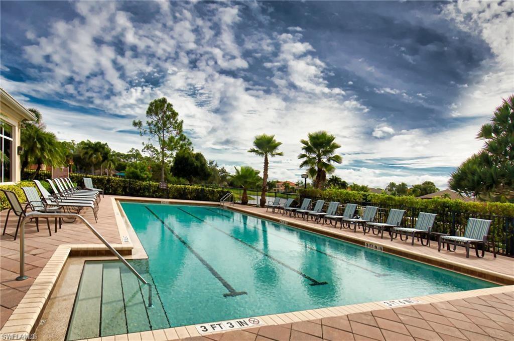 1415 Princess Sabal Point Naples, FL 34119 - Photo 34 of 42 Rectangular swimming pool with lane markers, integrated entry steps, and a surrounding paver deck