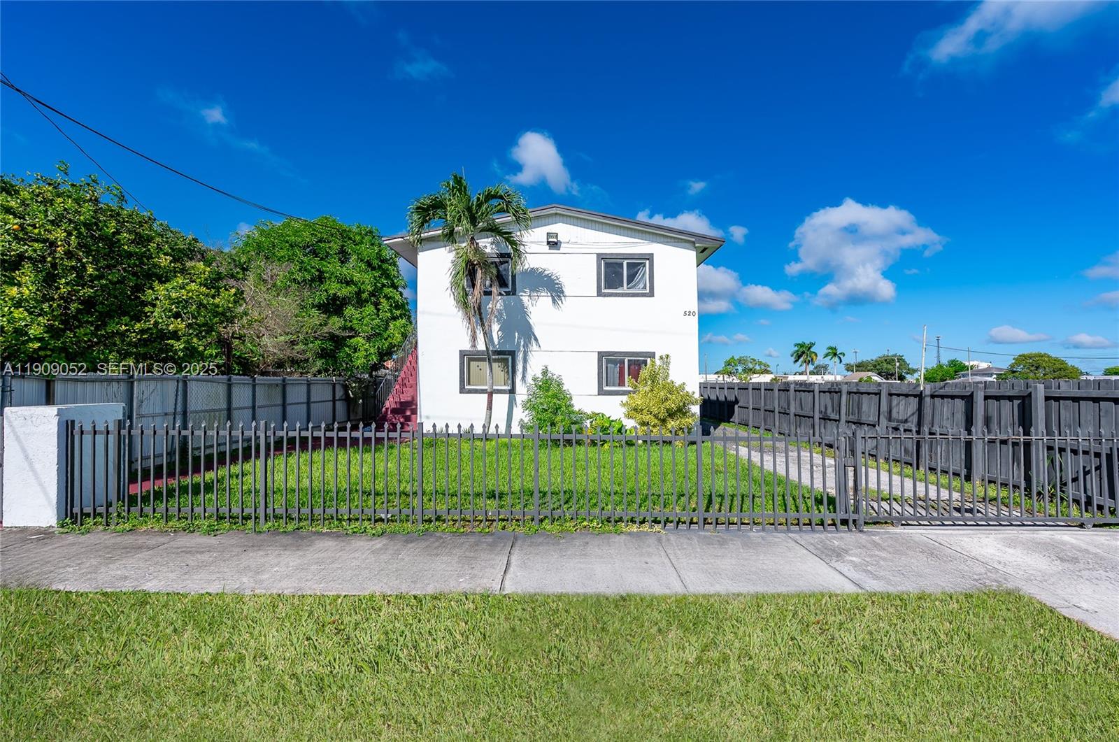 520 Southwest Krome Terrace Homestead, FL 33030 - Photo 1 of 17 a front view of a house having yard
