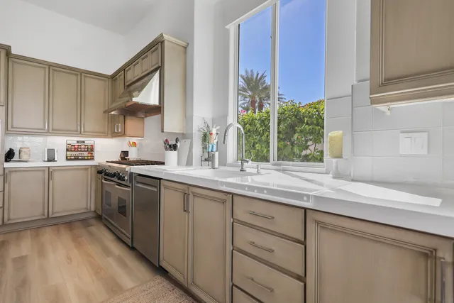 a kitchen with a sink stove and cabinets